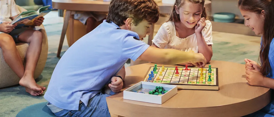 Children playing a board game at the kids club