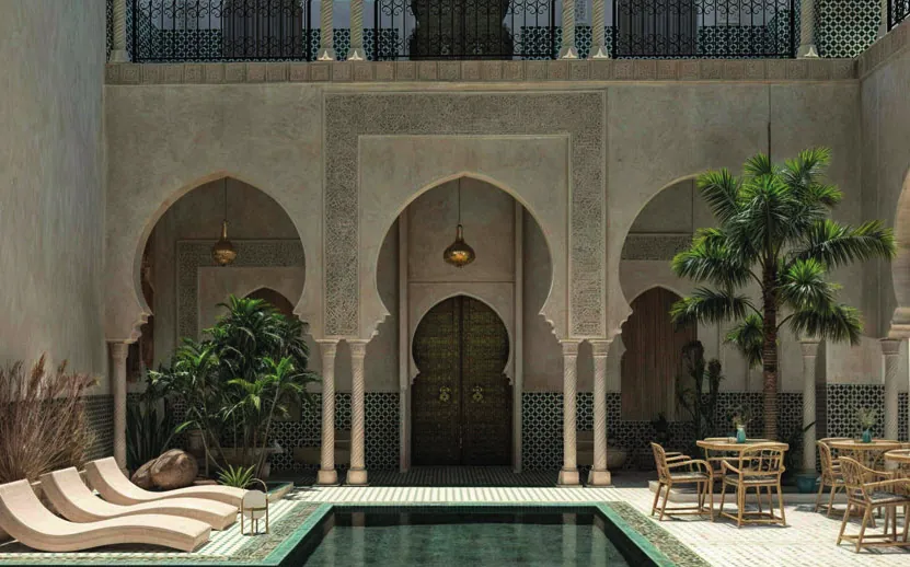 Riad courtyard with carved arches and a pool